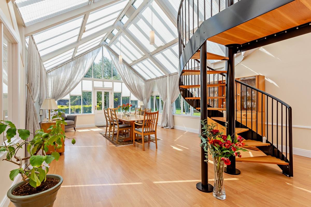 The 27ft dining room under a glass roof, looking onto the garden